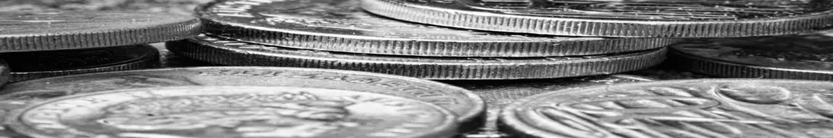 Close up of various coins in black and white.