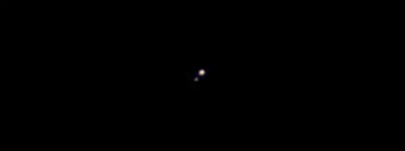 Pluto & it's first moon Charon.